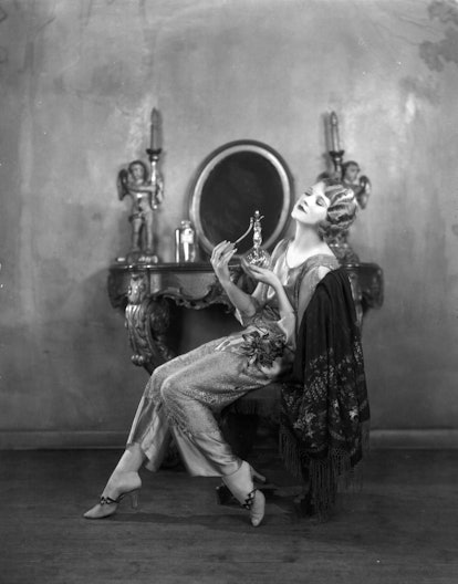 Actress Thalia Barbarova applies perfume at her dressing table in 1925. Photo by Sasha/Hulton Archiv...